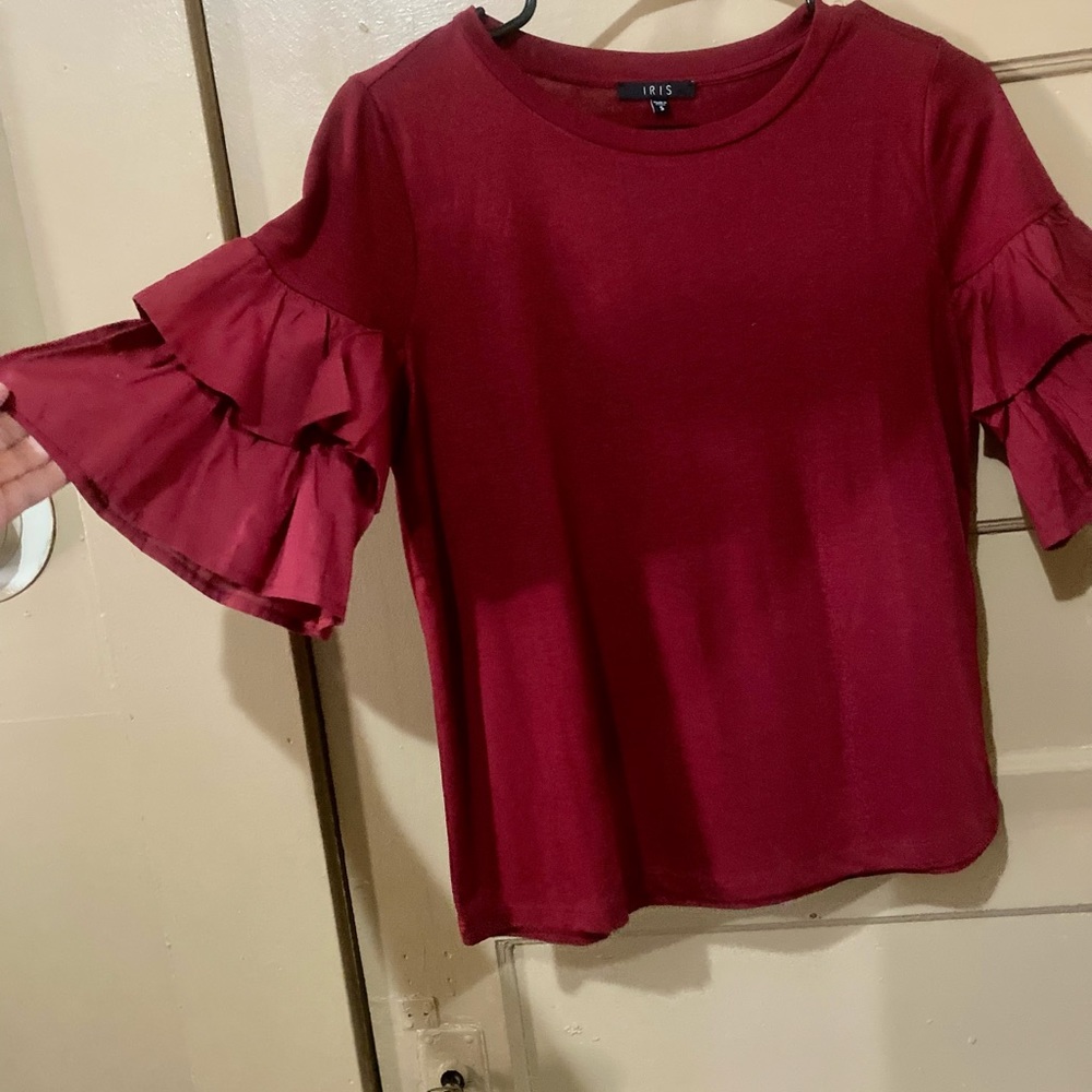 Ruffle sleeve burgundy shirt by Iris. Size Small but can fit a Medium.